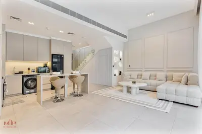 a living room with a couch and a kitchen at Spacious 4 Bed Villa with Private Pool and Meydan in Dubai
