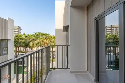 a balcony with a view of palm trees at Spacious 4 Bed Villa with Private Pool and Meydan in Dubai