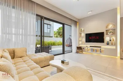 a living room with a couch and a tv at Spacious 4 Bed Villa with Private Pool and Meydan in Dubai