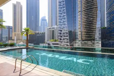 a swimming pool with a view of a city at Damac Upper Crest 2BR Dubai Mall Near 5 min walk in Dubai