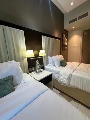 a hotel room with two beds and a table at Damac Upper Crest 2BR Dubai Mall Near 5 min walk in Dubai