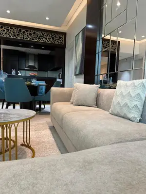 a living room with a couch and a table at Damac Upper Crest 2BR Dubai Mall Near 5 min walk in Dubai