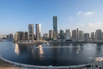 a view of a city with a river and buildings at Stayshort - 1 Bedroom in Business Bay with Canal Views that Sleeps 4 in Dubai