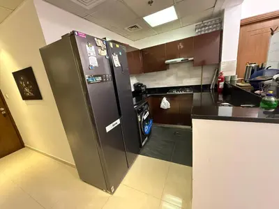 a kitchen with a large stainless steel refrigerator at Mavies Estate Al Jaddaf by Marriot in Dubai