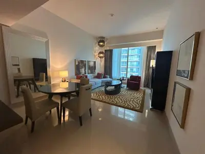 a living room with a table and chairs and a living room at Mavies Estate Al Jaddaf by Marriot in Dubai