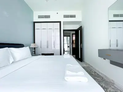 a bedroom with a large white bed with white pillows at Blissful Escape 2 BDR In Bayz-19 in Dubai