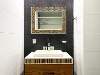 a bathroom with a white sink and a mirror at Blissful Escape 2 BDR In Bayz-19 in Dubai