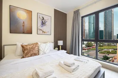 a bedroom with a large bed and a large window at Dubai Icon Suite at Miska 2 in Dubai