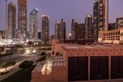 a view of a city with tall buildings at night at Dubai Icon Suite at Miska 2 in Dubai