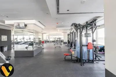 a gym with a lot of equipment in a room at Vogue Sports City Hera Tower Near First Avenue Mall, Studio Apartment with Balcony, Canal and City View, Access to all Amenities in Dubai
