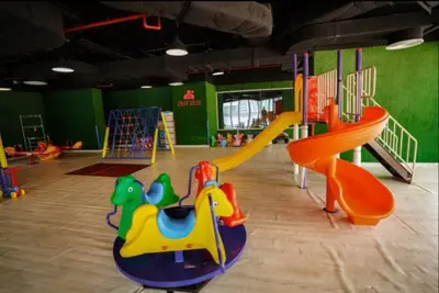 a childrens play room with colorful playground equipment at Vogue Sports City Hera Tower Near First Avenue Mall, Studio Apartment with Balcony, Canal and City View, Access to all Amenities in Dubai