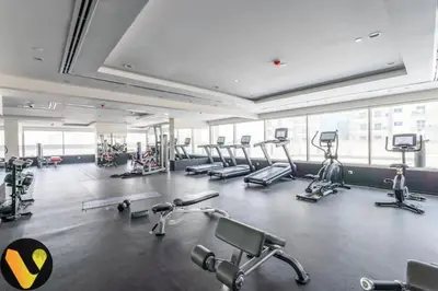 a gym with several treadmills and machines in a room at Vogue Sports City Hera Tower Near First Avenue Mall, Studio Apartment with Balcony, Canal and City View, Access to all Amenities in Dubai