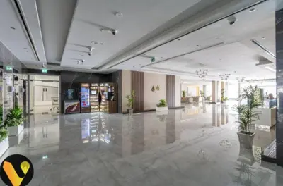 a large room with a lobby with potted plants at Vogue Sports City Hera Tower Near First Avenue Mall, Studio Apartment with Balcony, Canal and City View, Access to all Amenities in Dubai