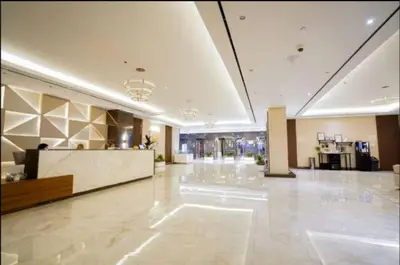a large lobby with a large white floor and a lobbyasteryasteryasteryasteryastery at Vogue Sports City Hera Tower Near First Avenue Mall, Studio Apartment with Balcony, Canal and City View, Access to all Amenities in Dubai