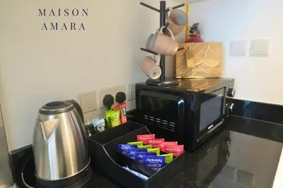a kitchen counter with a microwave and a coffee pot at Modern Luxury Studio Damac Hills With Golf View in Dubai