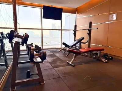 a gym with cardio equipment in a building at Modern Luxury Studio Damac Hills With Golf View in Dubai