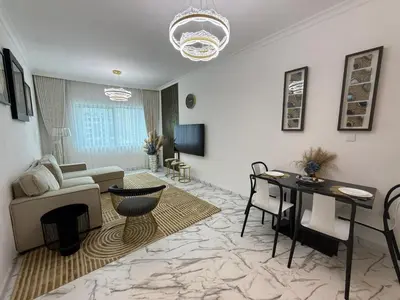 a living room with a couch and a table at Luxury 1BDR in the heart of Marina Walk to Metro & Promenade #11 in Dubai
