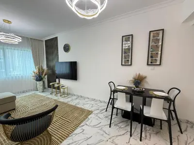 a living room with a table and chairs at Luxury 1BDR in the heart of Marina Walk to Metro & Promenade #11 in Dubai
