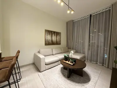 a living room with a couch and a table at Sky High Premium 1BR with Stunning Views in Dubai