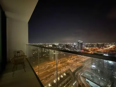 a room with a view of a city at night at Sky High Premium 1BR with Stunning Views in Dubai