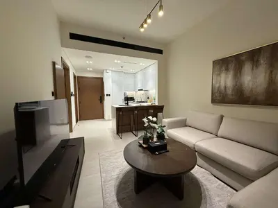 a living room with a couch and a table at Sky High Premium 1BR with Stunning Views in Dubai