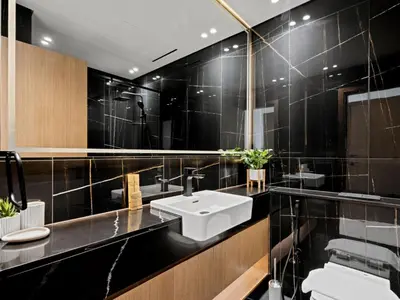 a black bathroom with a sink and a mirror at Aesthetic Elegance 1BDR in Binghatti Onyx in Dubai