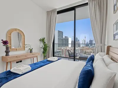 a bedroom with a bed and a large window at Aesthetic Elegance 1BDR in Binghatti Onyx in Dubai