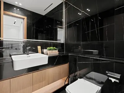 a bathroom with a sink and a toilet at Aesthetic Elegance 1BDR in Binghatti Onyx in Dubai