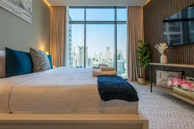 a bedroom with a large bed with a large window at 2 Bedroom in Peninsula with Burj View in Dubai