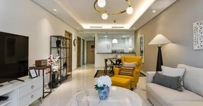 a living room with a couch and a table at Burj View 2BHK Downtown Infinity Pool in Dubai