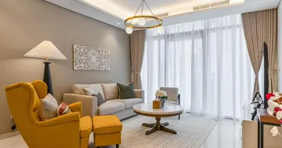 a living room with a couch and a table at Burj View 2BHK Downtown Infinity Pool in Dubai