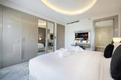 a bedroom with a white bed and a television at PNB Living - Luxury 2 Bedroom Apartment with High Floor - DAMAC Towers by Paramount Tower D in Dubai