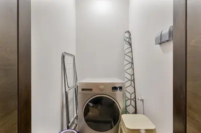 a washer and dryer in a small room at Beautiful 2BR at Majestique Residence Dubai South in Dubai