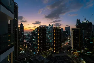 a view of a city skyline at night at GuestReady - 1BR l Burj Khalifa View in Dubai