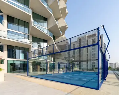 a tennis court in front of a building at Stylish 1BR at Binghatti Phantom with Private Pool in Dubai