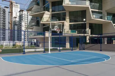 a basketball court in front of a building at Stylish 1BR at Binghatti Phantom with Private Pool in Dubai