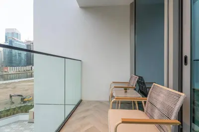 a balcony with chairs and a table with a view at GuestReady - Premium Location | Studio | Pool View in Dubai
