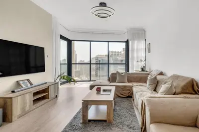 a living room with a couch and a flat screen tv at Scenic Lakeview Stay Stylish 1 Bedroom in JLT in Dubai