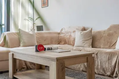 a living room with a couch and a coffee table at Scenic Lakeview Stay Stylish 1 Bedroom in JLT in Dubai