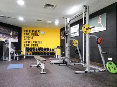 a gym with several machines and a sign on the wall at Scenic Lakeview Stay Stylish 1 Bedroom in JLT in Dubai
