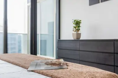a bedroom with a bed with a book on it at Scenic Lakeview Stay Stylish 1 Bedroom in JLT in Dubai