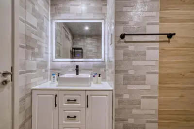 a bathroom with a white sink and a mirror at Scenic Lakeview Stay Stylish 1 Bedroom in JLT in Dubai