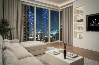 a living room with a couch and a large window at Daniels 2BR at Creek Gate with Canal View in Dubai