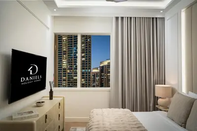 a hotel room with a bed and a large window at Daniels 2BR at Creek Gate with Canal View in Dubai