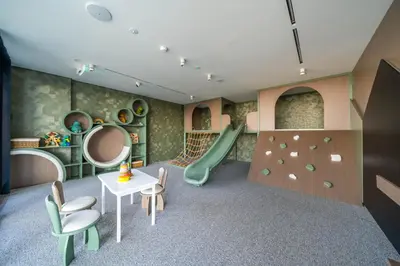 a childrens play room with a slide at 1BR Sunlit Modern Retreat with Private Sunbeds in Dubai