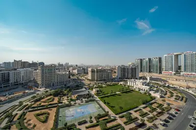 an aerial view of a city with tall buildings at 1BR Sunlit Modern Retreat with Private Sunbeds in Dubai