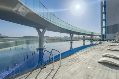 a bridge over a body of water in a building at Peaceful High-Rise Studio Overlooking Miracle Garden, Skyz by Danube, Arjan by Deluxe Holiday Homes in Dubai