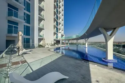a view of a building with a swimming pool at Peaceful High-Rise Studio Overlooking Miracle Garden, Skyz by Danube, Arjan by Deluxe Holiday Homes in Dubai