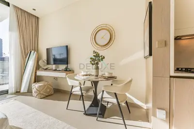 a small dining room with a table and chairs at Well-Appointed Studio, Minutes from Circle Mall and Community Parks - Binghatti Phoenix, Jumeirah Village Circle by Deluxe Holiday Homes in Dubai