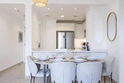 a dining room with a table and chairs at Contemporary 2BR in JVC With Pool, Gym & Relaxing Stay in Dubai
